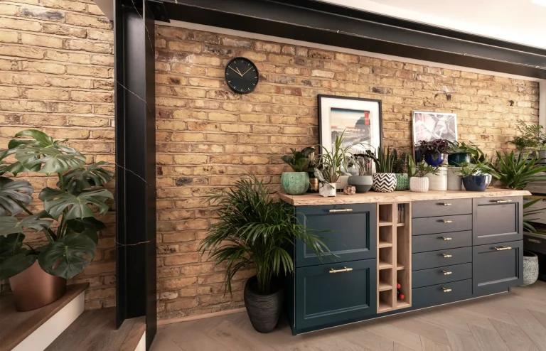 Navy units with wine rack against an exposed brick wall